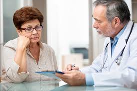 Doctor discussing hypertension management with an elderly woman to help her take control of high blood pressure