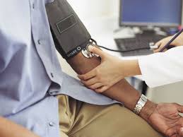 Doctor checking a patient's blood pressure to help take control of hypertension