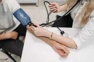 🌱 Stay Ahead of Silent Killers: Monitor Blood Pressure, Sugar & More 🌱 1 Doctor checking a patient's blood pressure to help take control of hypertension